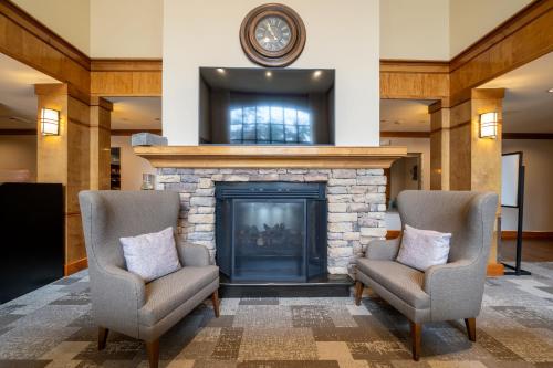 a living room with two chairs and a fireplace at Staybridge Suites Houston West - Energy Corridor by IHG in Houston