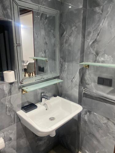 a bathroom with a sink and a mirror at Appartement City Agadir 2 in Agadir
