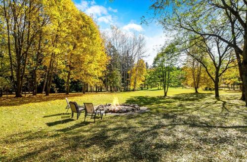 two chairs and a fire pit in a park at Mono Farmhouse in Caledon