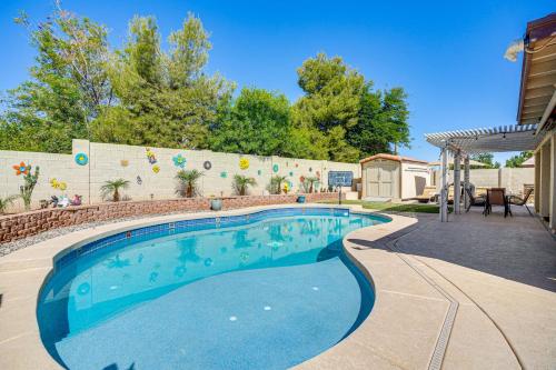a swimming pool in the backyard of a house at Pool, Patio and Hot Tub Surprise Home Near Golfing! in Surprise