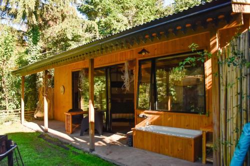 a wooden house with a tub in a yard at Increíble cabaña, naturaleza, a 300m del mar, Pinamar in Pinamar