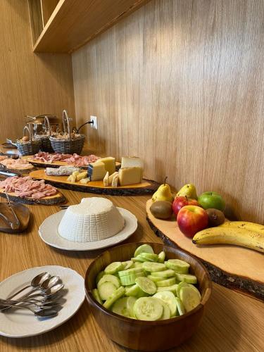 a table topped with plates and bowls of fruits and vegetables at Villa Cavalletti in Grottaferrata