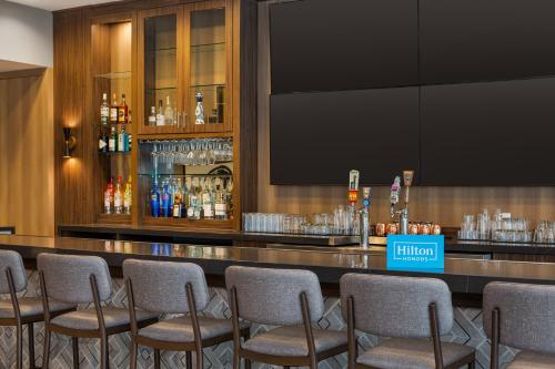a bar with a bunch of chairs around it at Home2 Suites By Hilton Houston Downtown Convention Center in Houston