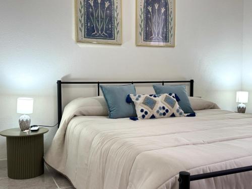 a bedroom with a large bed with pillows on it at Casa Lia - Independent apartment in the Gulf of Orosei in Galtellì