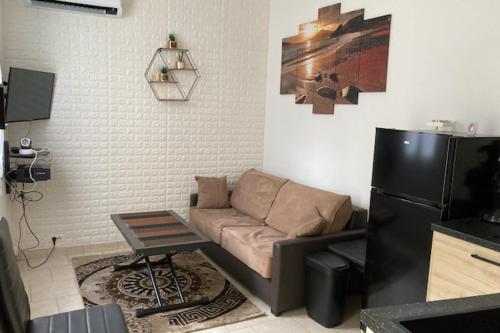 - un salon avec un canapé et un réfrigérateur dans l'établissement Beautiful 1-bedroom apartment - near the beach, à Cannes