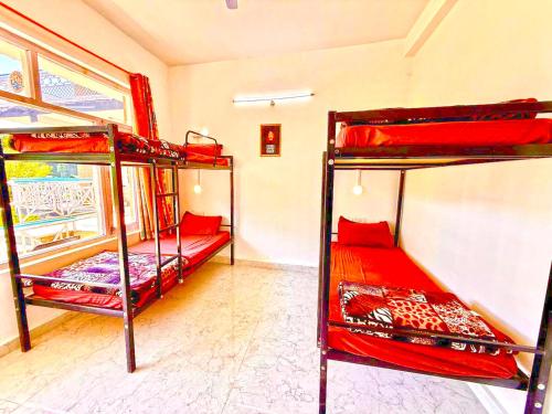 a room with two bunk beds and a window at Hotel The Premium Villa Old Manali View in Manāli