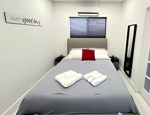 a bedroom with a large bed with a red pillow at Pretty Private Room, near the Airport - Free parking - 01 in Miami