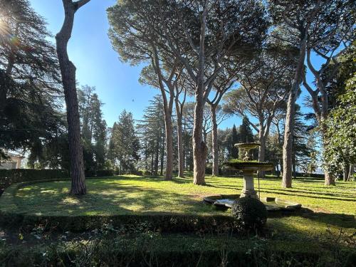 a park with a bird bath in the grass at Villa Cavalletti in Grottaferrata