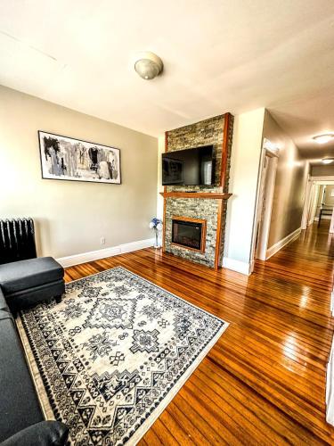 a living room with a couch and a fireplace at The Red House Albany NY 4 Bedroom Private Apartment in Albany