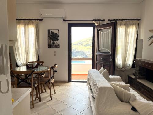 a living room with a couch and a table at Residence Sineti Beach sea view maisonette in Sinétion