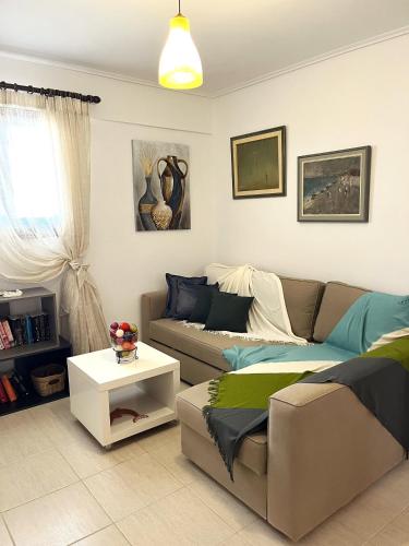 a living room with a couch and a table at Residence Sineti Beach sea view maisonette in Sinétion