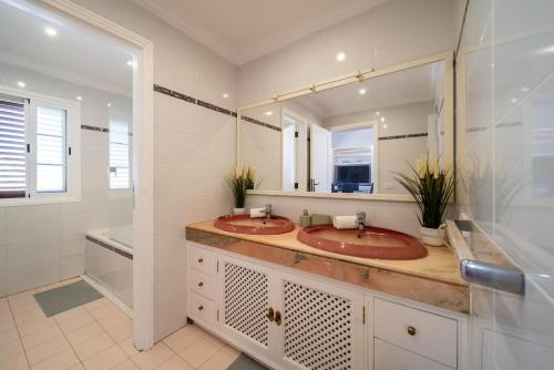 a bathroom with two sinks and a large mirror at VillaSue in Tías