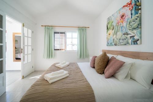 a bedroom with a large bed with two towels on it at VillaSue in Tías