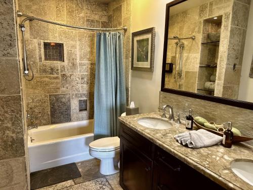 a bathroom with a sink and a toilet and a shower at Ocean View Retreat W Pool Access in Avalon