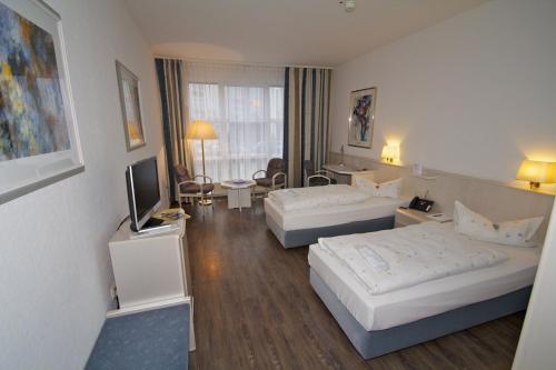 Ένα ή περισσότερα κρεβάτια σε δωμάτιο στο Euro Park Hotel Hennef