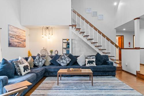 a living room with a blue couch and a table at Spacious Game Room Seclusion Hot Tub and more in Long Pond