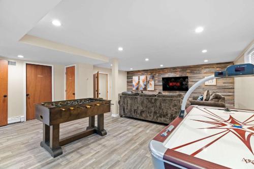 a room with a pool table and a couch at Spacious Game Room Seclusion Hot Tub and more in Long Pond