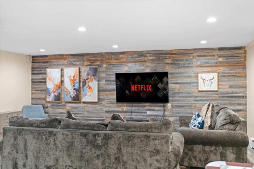 a living room with two couches and a television at Spacious Game Room Seclusion Hot Tub and more in Long Pond
