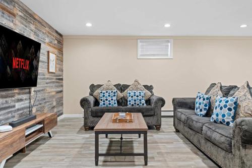 a living room with two couches and a coffee table at Spacious Game Room Seclusion Hot Tub and more in Long Pond