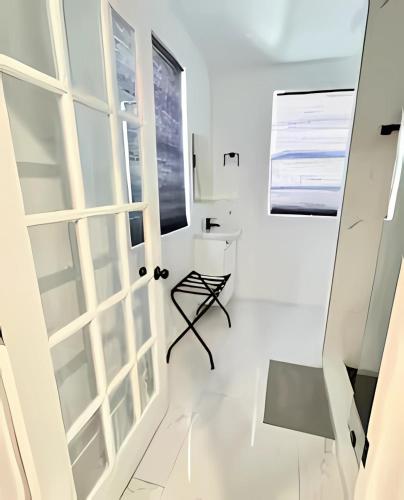 a white room with a door and a chair at Pretty Private Room, near the Airport - Free parking - 01 in Miami