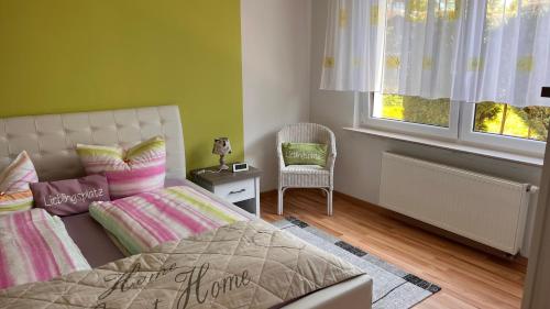 a bedroom with a bed and a chair and a window at Radfahrer Oase in Hameln direkt am Weser Radweg in Hameln