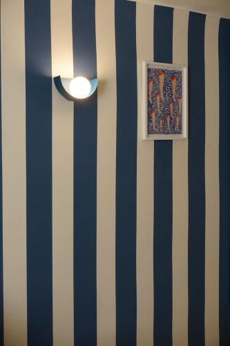 a room with blue and white stripes on a wall at Casaïa La Sudiste Chambre avec salle de bain privée in Hyères