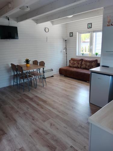 a living room with a table and a couch at Gęsia Saga in Kruszwica