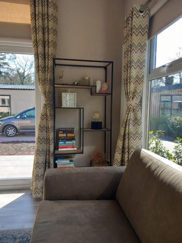 a living room with a couch and a window at PrinsHeerlijk in Harderwijk