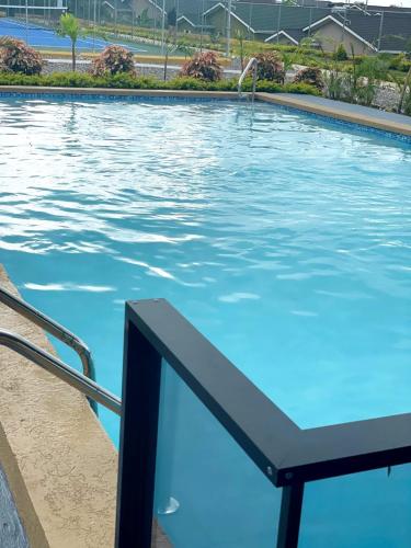 a large swimming pool with blue water at Falmouth Trelwany Stonebrook Manner in Falmouth