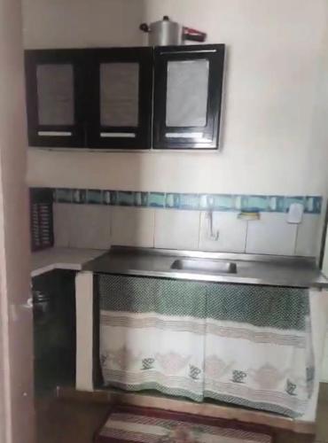 a kitchen with a sink and a counter top at Suites&Flats Galinhos in Galinhos