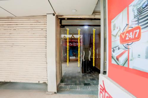 a hallway in a building with a garage door at SPOT ON Hotel Swarat in Satna
