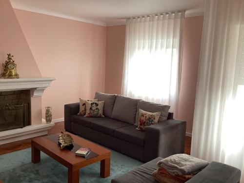 a living room with a couch and a window at Casa das Cales - Grande in Angra do Heroísmo