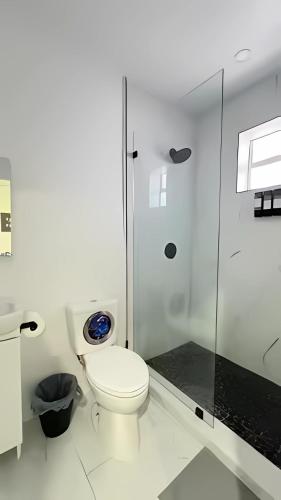 a white bathroom with a toilet and a shower at Cozy Private Room, near the Airport - Free parking - 01 in Miami