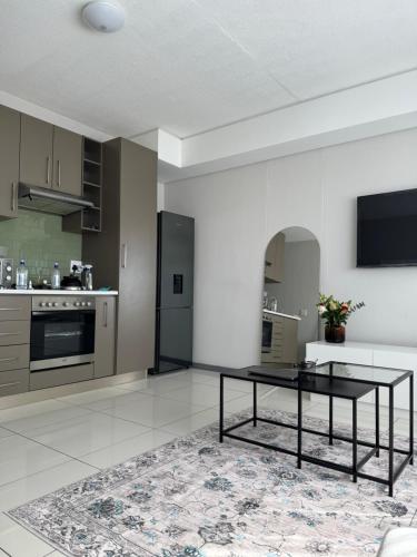a kitchen with a black table in a room at Haven at Merensky in Windhoek