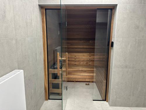 a glass door to a shower in a bathroom at Jungle Apartment in Krakow