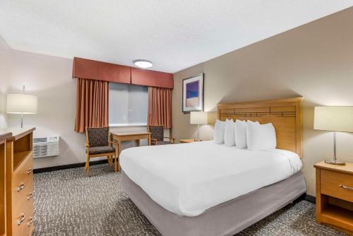 a hotel room with a large bed and a desk at Best Western Aladdin Inn in Kelso