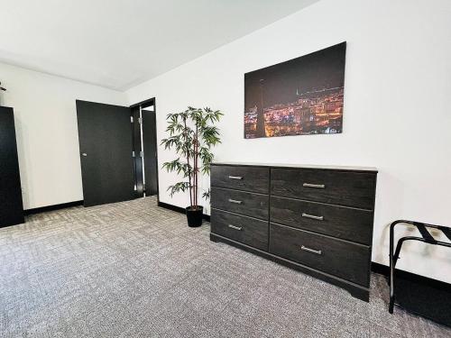 a room with a dresser and a tv on a wall at The 419 Ten-room Boutique In Sandusky in Sandusky