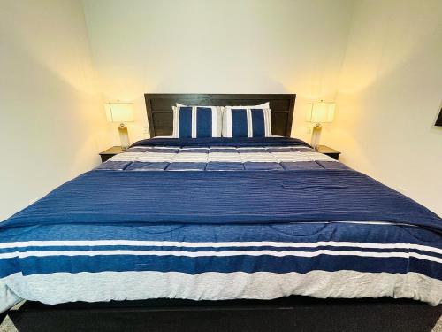 a bedroom with a blue and white bed with two lamps at The 419 Ten-room Boutique In Sandusky in Sandusky