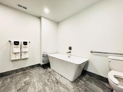 a white bathroom with a sink and a toilet at The 419 Ten-room Boutique In Sandusky in Sandusky