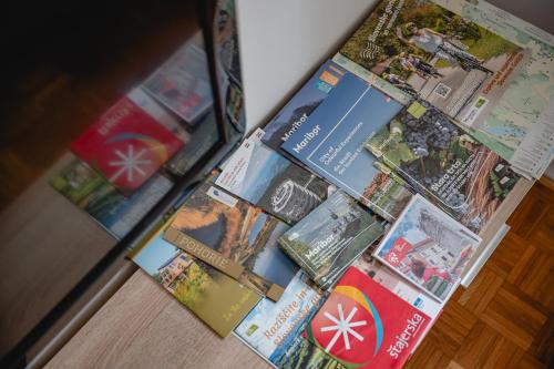 a bunch of magazines sitting on top of a table at Apartma Golob in Maribor