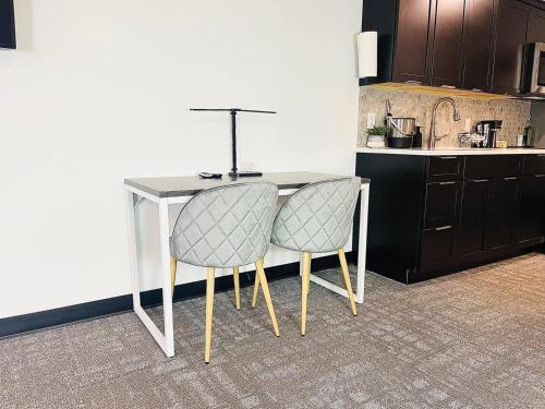 a table and two chairs in a kitchen at The 419 Ten-room Boutique In Sandusky in Sandusky