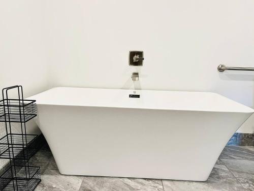 a white sink with a faucet on a wall at The 419 Ten-room Boutique In Sandusky in Sandusky