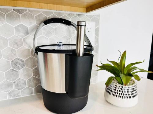 a blender sitting on a counter next to a plant at The 419 Ten-room Boutique In Sandusky in Sandusky