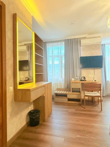 a bathroom with a yellow mirror and a sink at Boutique Hotel Tiflis in Tbilisi City