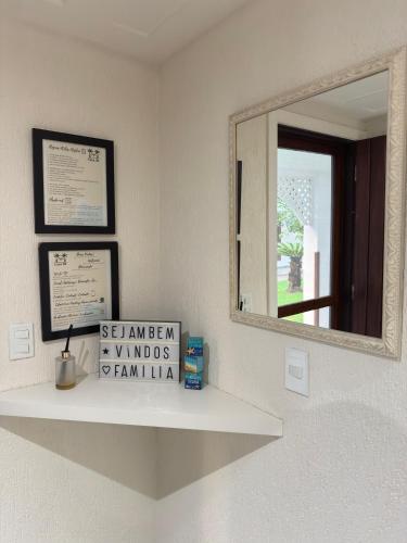 a mirror sitting on a shelf in a bathroom at Le Corsaire, 38 in Búzios