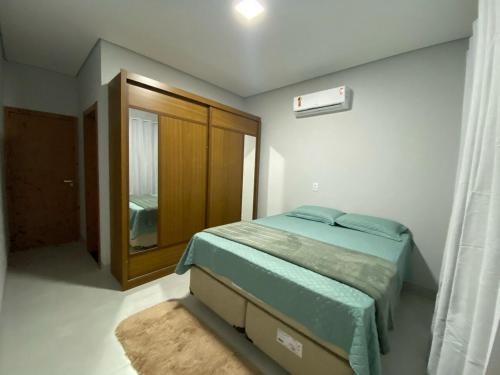 a small bedroom with a bed and a window at Apartamento novo no centro de Sinop! in Sinop