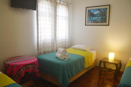 a small room with two beds with a stuffed animal on a pillow at Casa Rodas in Lima