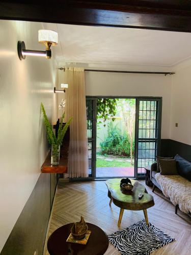 a living room with a couch and a table at Pleasant Places in Kabubu
