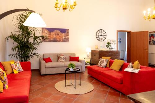 a living room with two red couches and a table at Luna Prime Collection Catania in Catania
