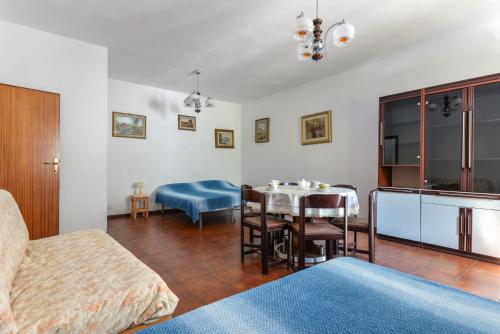 a bedroom with a bed and a table and chairs at Casa Vacanza Costa del Sole in Pomonte